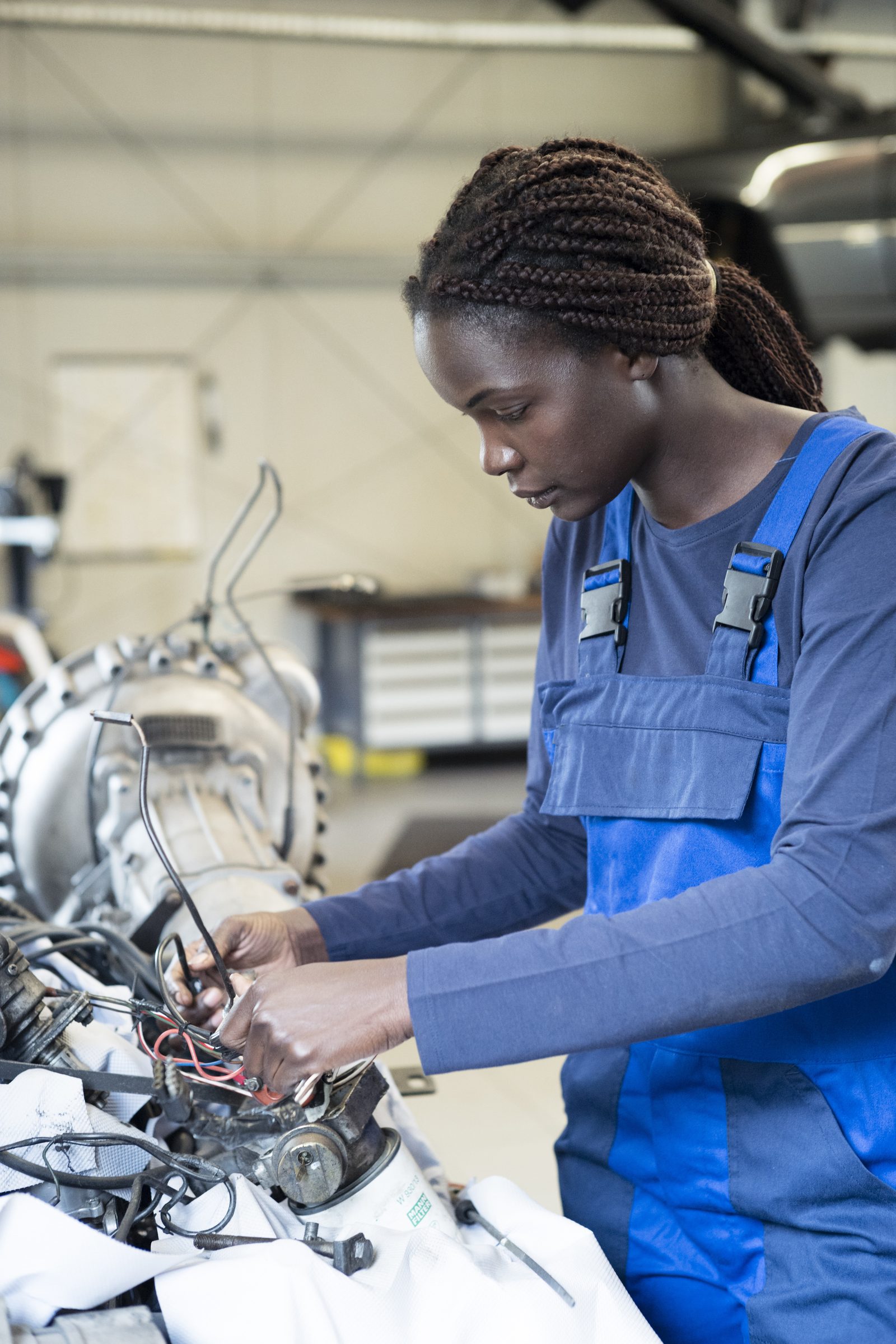 A technician working on an engine assembly in a workshop